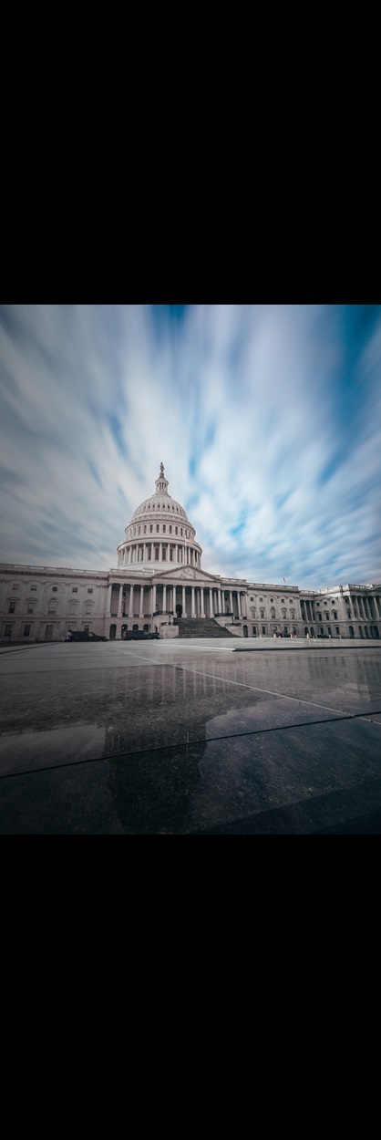 Capitol building with clouds and reflection