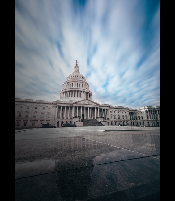 Capitol building with clouds and reflection