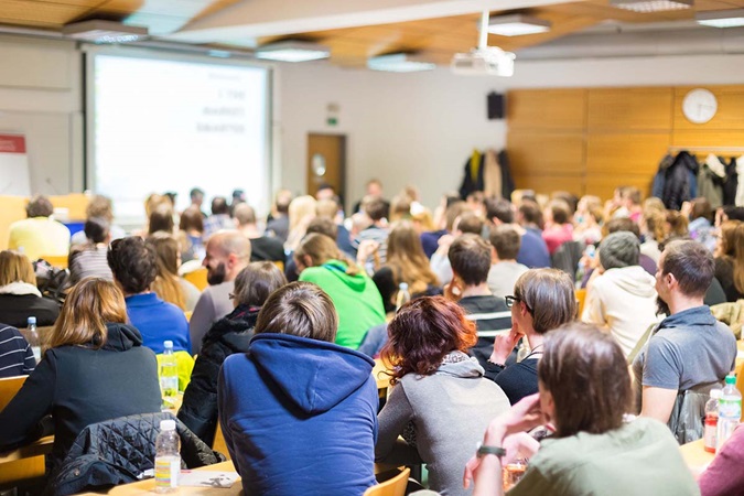 Students listening to lecture in a large classroom