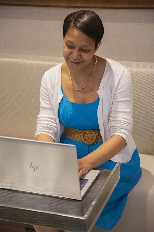 Woman smiling at computer